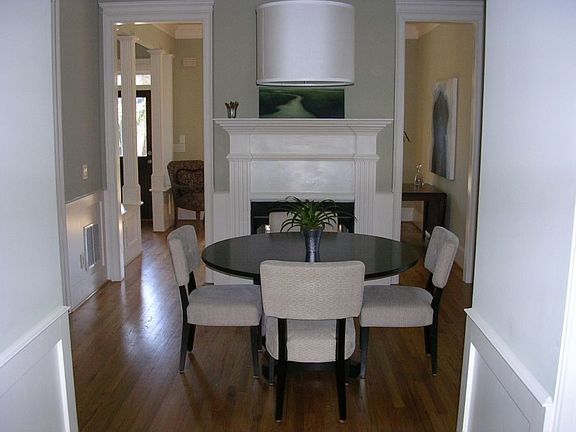 The dining room features a pass through gas fireplace, hardwoods, chair railing and custom built-ins.