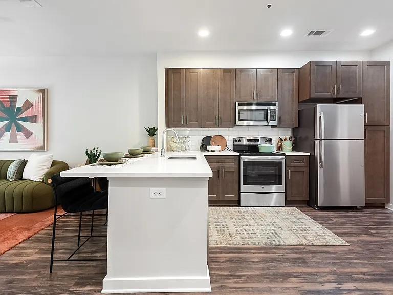 Spacious Kitchen with Sleek Cabinetry and Stainless Steel Finishes