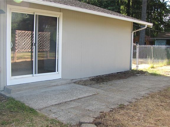This patio, just off of the kitchen, allows you to easily bring the fun outdoors. Who's in the mood for some grilling? Notice the fenced back yard?