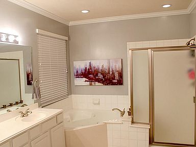 SPACIOUS 5 PIECE MASTER BATH WITH CROWN MOLDING AND JET TUB IS A RELAXING OASIS TO SOAK AWAY YOUR WORRIES