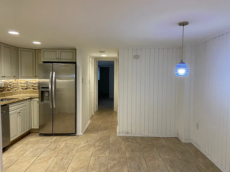 Kitchen and hallway towards bedroom and bathroom.