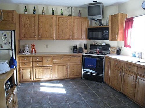 New tile floor and dishwasher, wall mounted TV stays