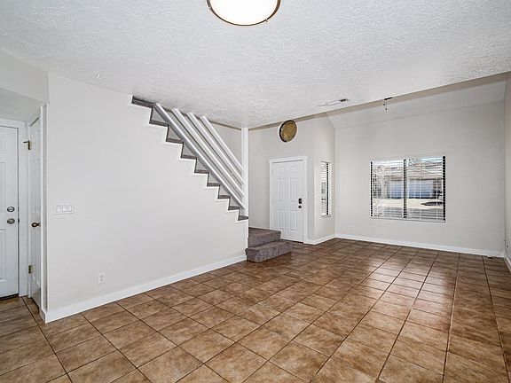 living and dinning room. Front door and entrance to garage.