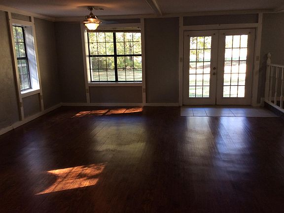 Large living room. French doors open to large front porch. Laminant flooring.