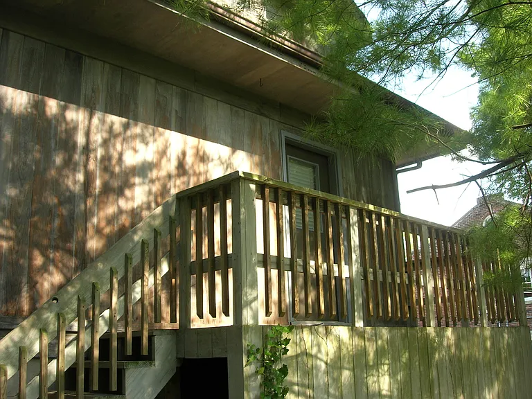 Private entrance with small deck overlooking greenspace