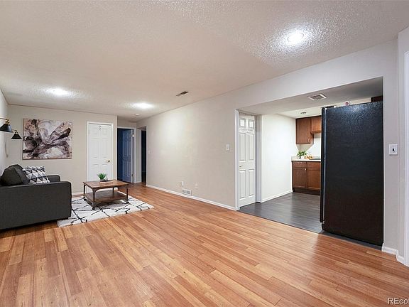 Downstairs living area + kitchen. large laundry room behind door in photo. front-loading W/D included.