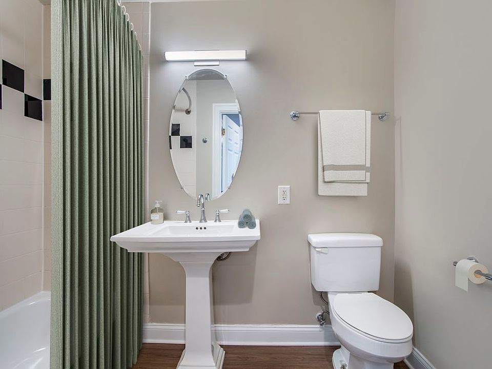 Renovated Package II bathroom with white countertops and hard surface flooring