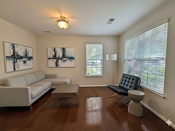 First level den, iving, or office with real gleamimng hardwood floors.

**This image is vitually staged with furniture and wall art for illustrative purposes**