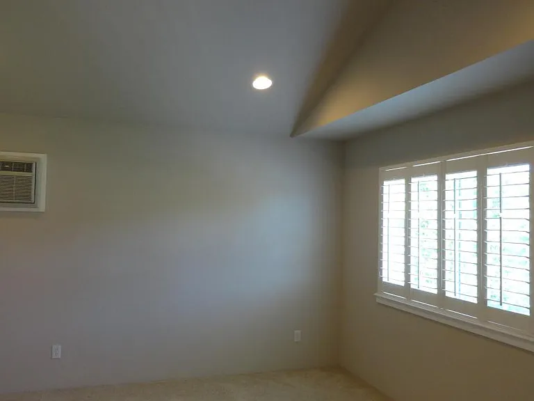 Master Bedroom with Vaulted Ceilings, natural light with views to the park and brand new ductless heat and AC (not shown).