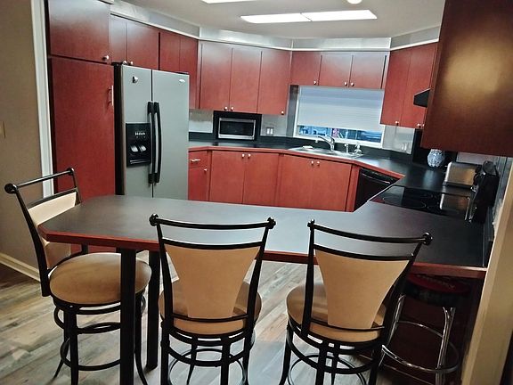 Bar with kitchen beyond