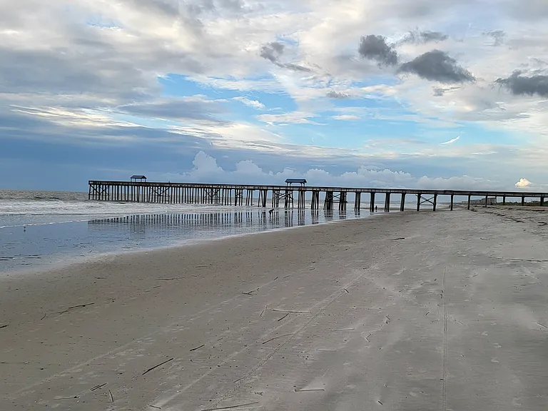 Adjacent to the pier and across the street from The Surf restaurant and bar.