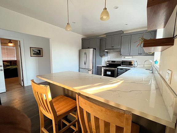 Brand New Kitchen with seating and QUARTZ countertops and ample lighting