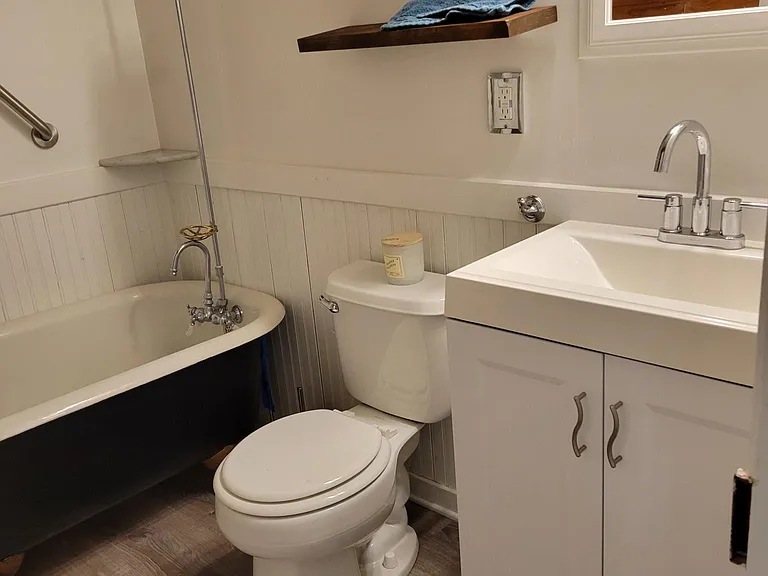 newly remodeled bathroom with claw foot tub and shower over