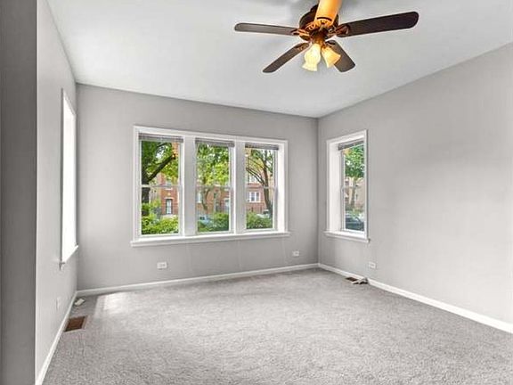 Large bright bedroom with new faux wood blinds throughout the apartment
