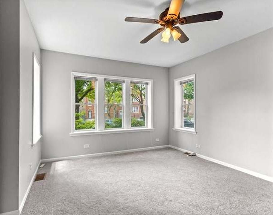 Large bright bedroom with new faux wood blinds throughout the apartment
