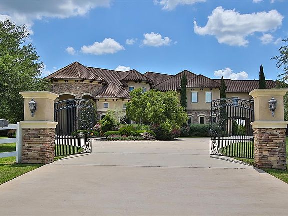 A wrought iron gate beckons you to enter the property and explore everything this home has to offer, all while providing added security with a HAI 8-camera security system!