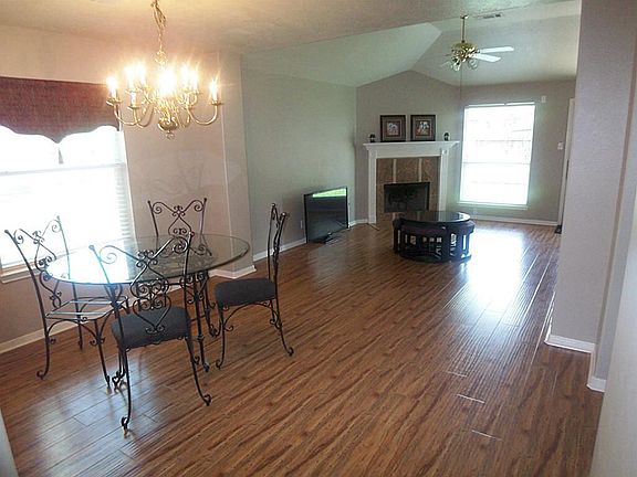 VIEW FROM ENTRY OF DINING AREA AND DEN. BEAUTIFUL WOOD LAMINATE FLOORS