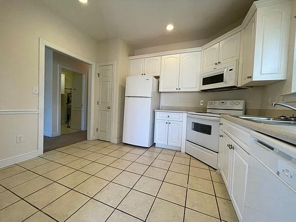 Kitchen - Refrigerator, stove, microwave, dishwasher, garbage disposal. Built in pantry.