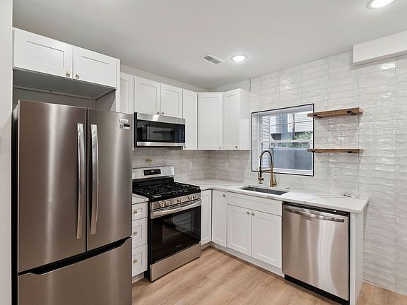 Kitchen with stone countertops and stainless steel appliances