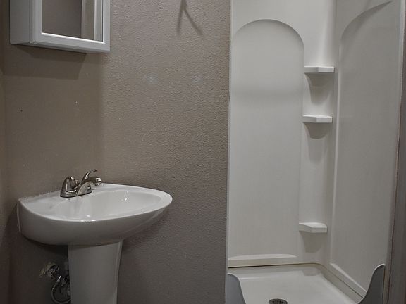 Primary bathroom, Clean, low-maintenance bathroom featuring a walk-in shower and updated fixtures.