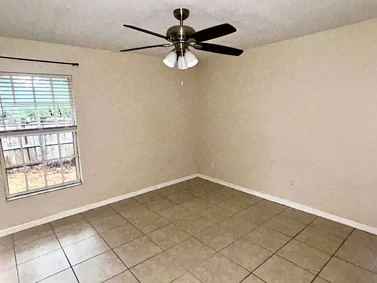 Picture of primary bedroom with newer ceiling fan