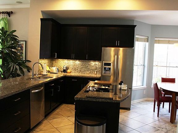 The kitchen has been upgraded and features stainless appliances & granite counters.