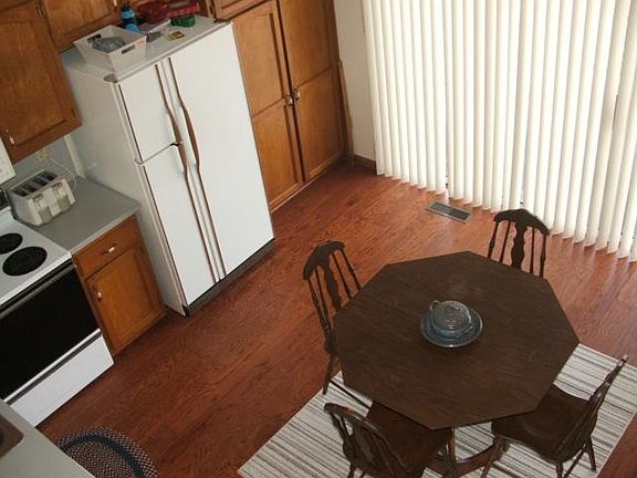 View from upstairs, has open shelves on top oak cabinets.