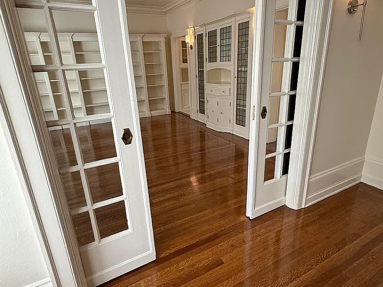 dining or living room view with french doors & built in book shelves and cabinet with leaded glass doors