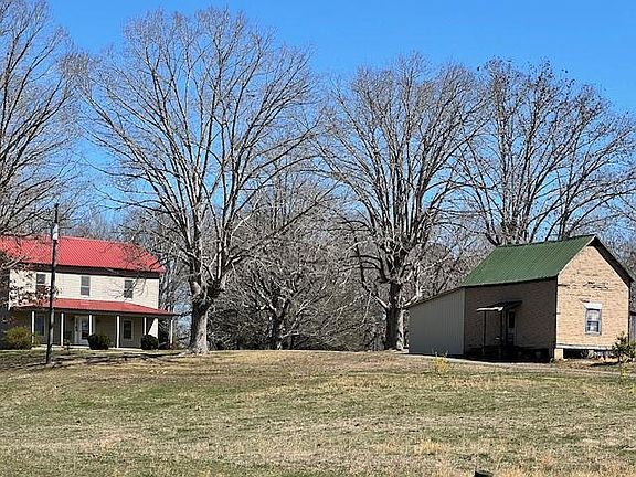 Farm house is at top of driveway. Other structure (packing house) is part of farm property.
