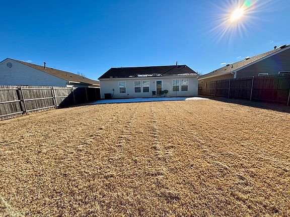 Large fenced backyard with glass storm door.