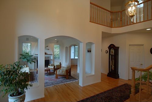 Dramatic entry with arches to living and dining rooms