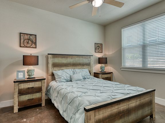Spacious Bedroom with lots of natural light and stained concrete floors