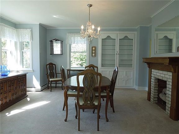 Large dining room with built in cabinet, bay window and gas fireplace