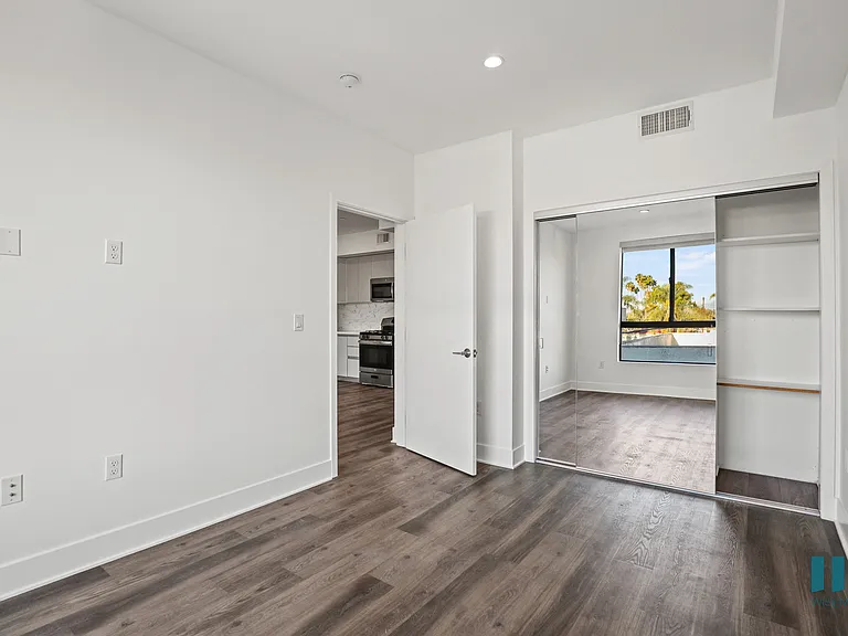 Bedroom with Mirrored Closet with Built-In Shelving