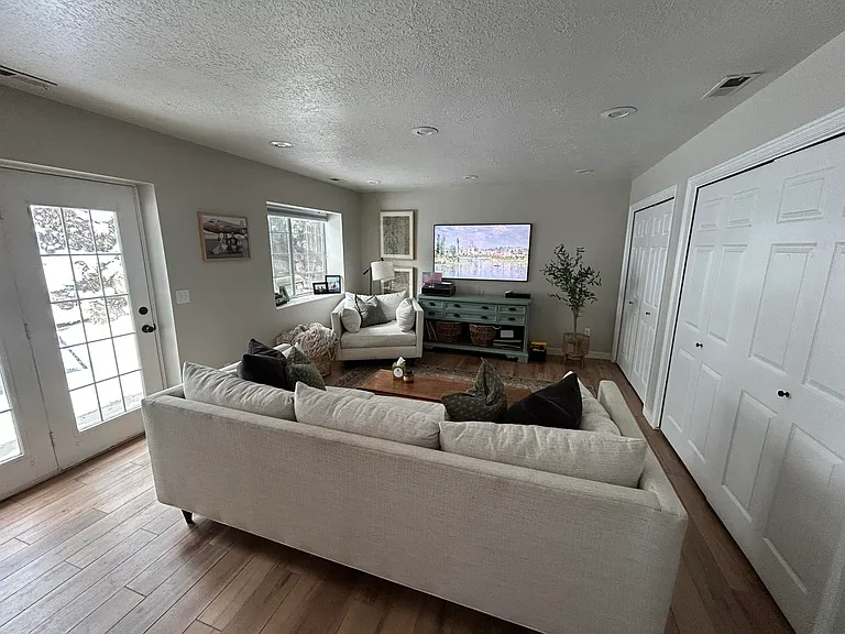 Living room with two-section patio doors into the backyard.
