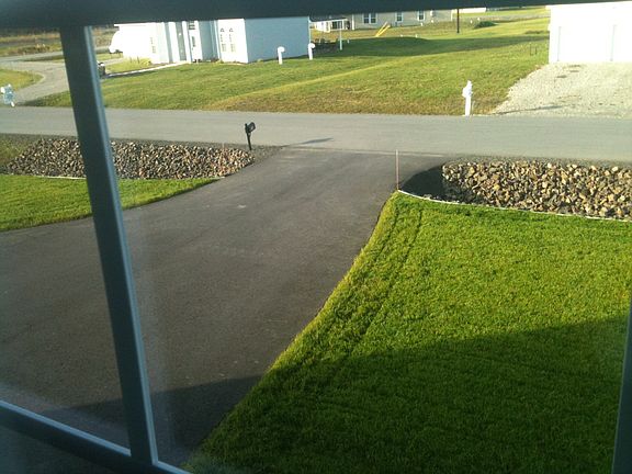 Asphalt driveway and custom landscaping as viewed from upsta