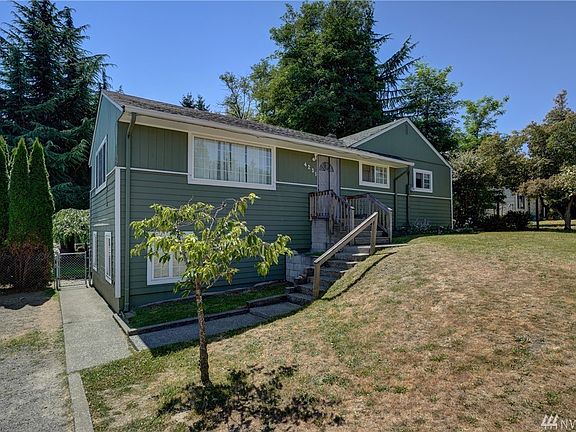Front view of home, ground level has private access door to basement. 