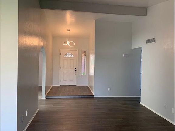 Living room with foyer to front door