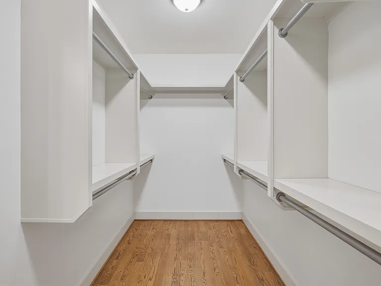 Find a comfortable queen bed in bedroom 3, along with a walk-in closet, dresser, smart TV, and ceiling fan.