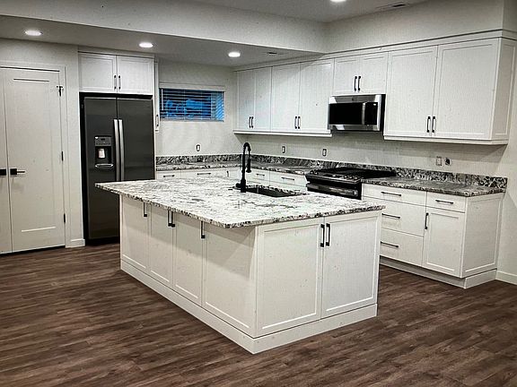 Kitchen island. There is more space than this photo indicates between the island and the cupboards on the wall behind it, as you can tell from the other kitchen pix.