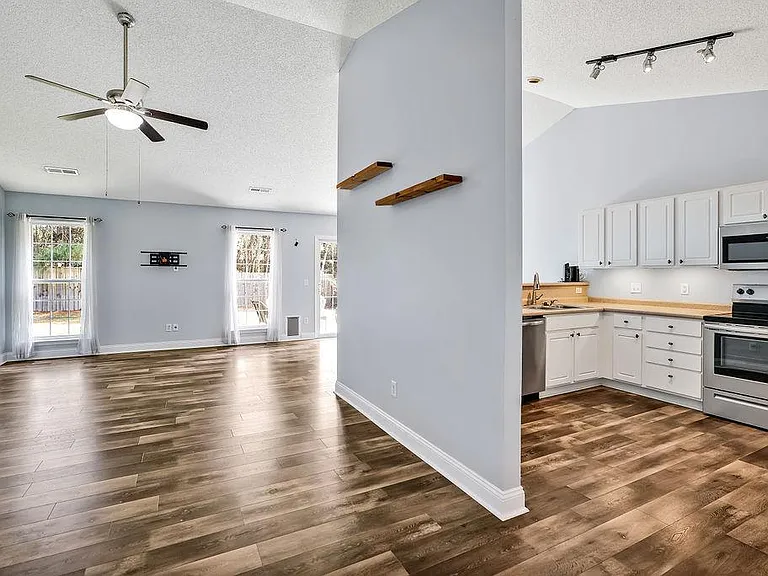 Living room and kitchen split by wall