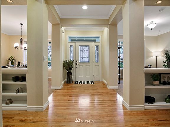 Welcoming entry with Red Oak flooring. Box beam ceiling and built-ins.