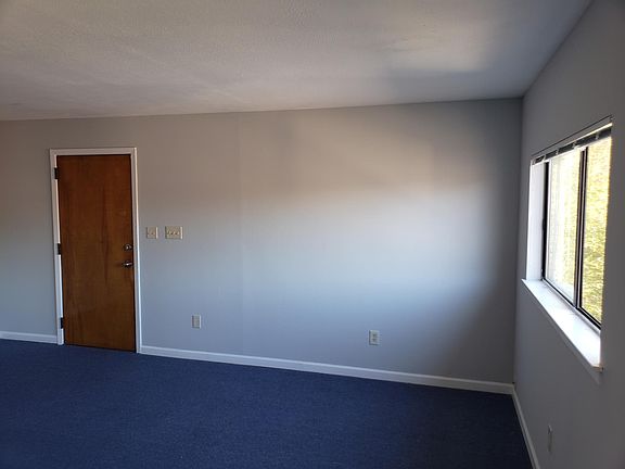 Living room/entry area that leads to dining room.