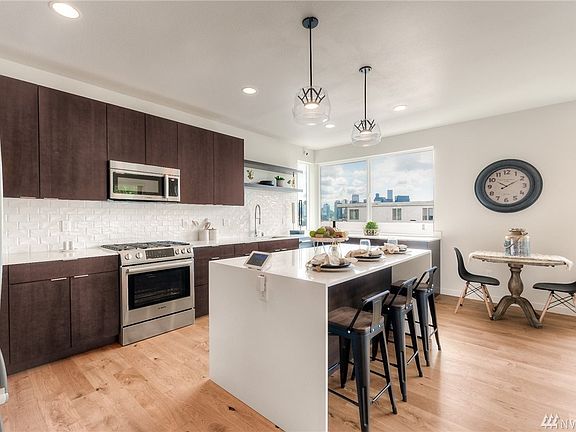 The chef will delight in the premium Bosch Appliances and spacious cooking area. A breakfast bar sits ready for casual dining or conversation. Additional dining space is available for larger gatherings.