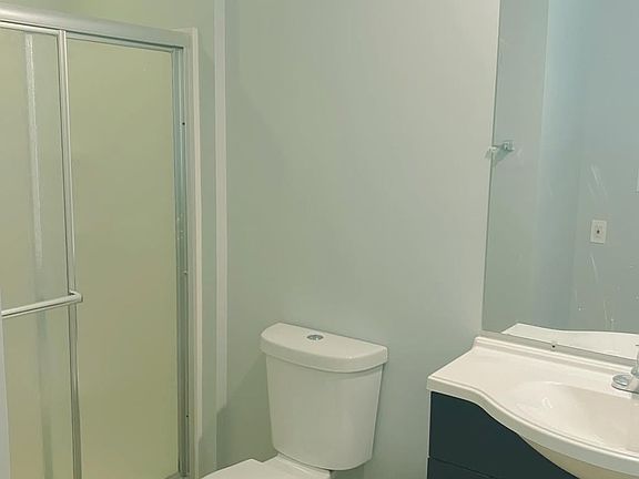 Clean, private bathroom with a walk-in shower and simple, functional finishes.