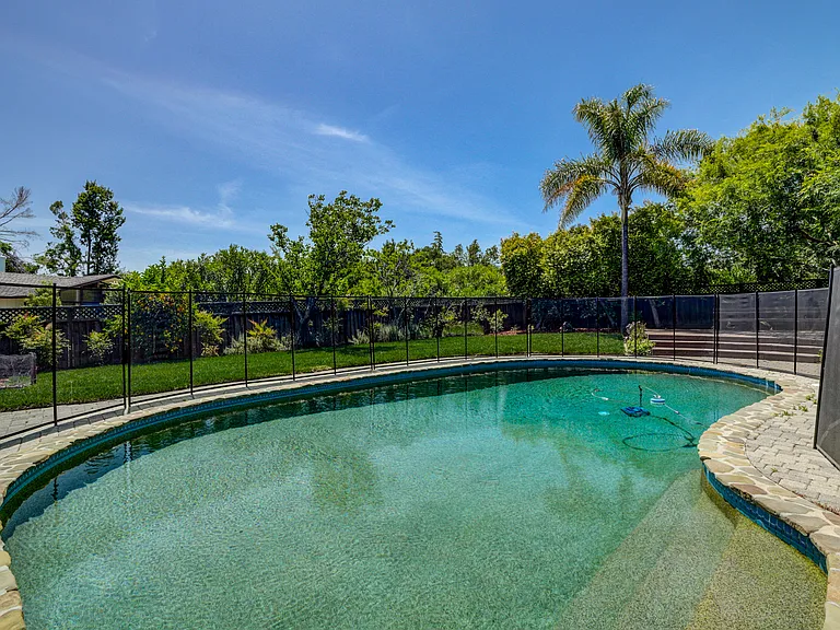A sparkling pool at the front and a wonderfuldeck beckoning for entertainment or relaxation.