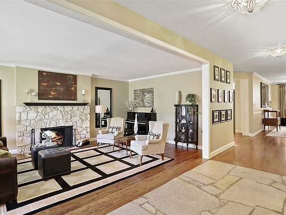 You'll notice the lush hardwoods throughout most of the main floor. Another original beauty - this granite wood burning fireplace in the living room.