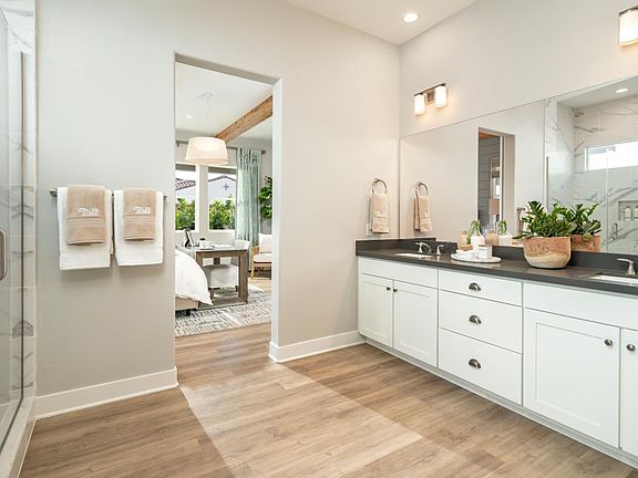 Primary bathroom features dual-sink vanity and large walk-in shower