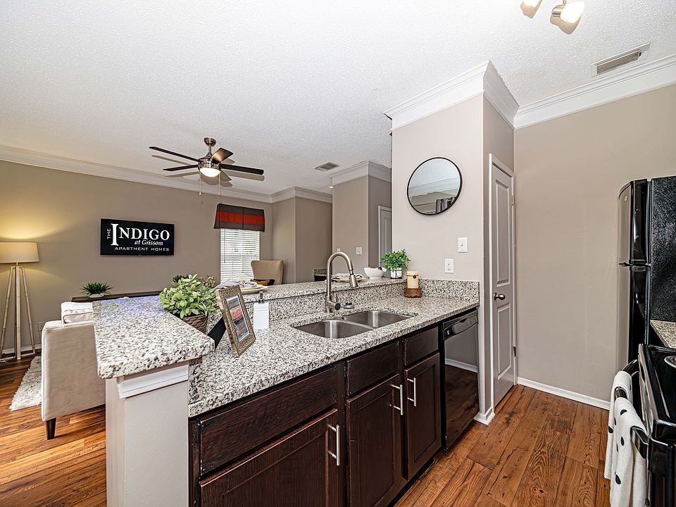 Kitchen with granite counters and black appliances