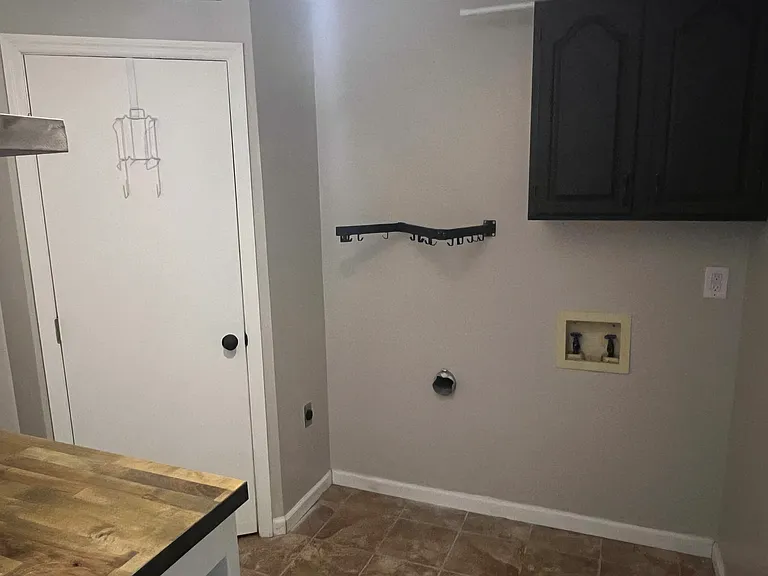 Laundry room with back door going out to backyard